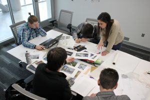 Photo of students reviewing materials at a rectangular table